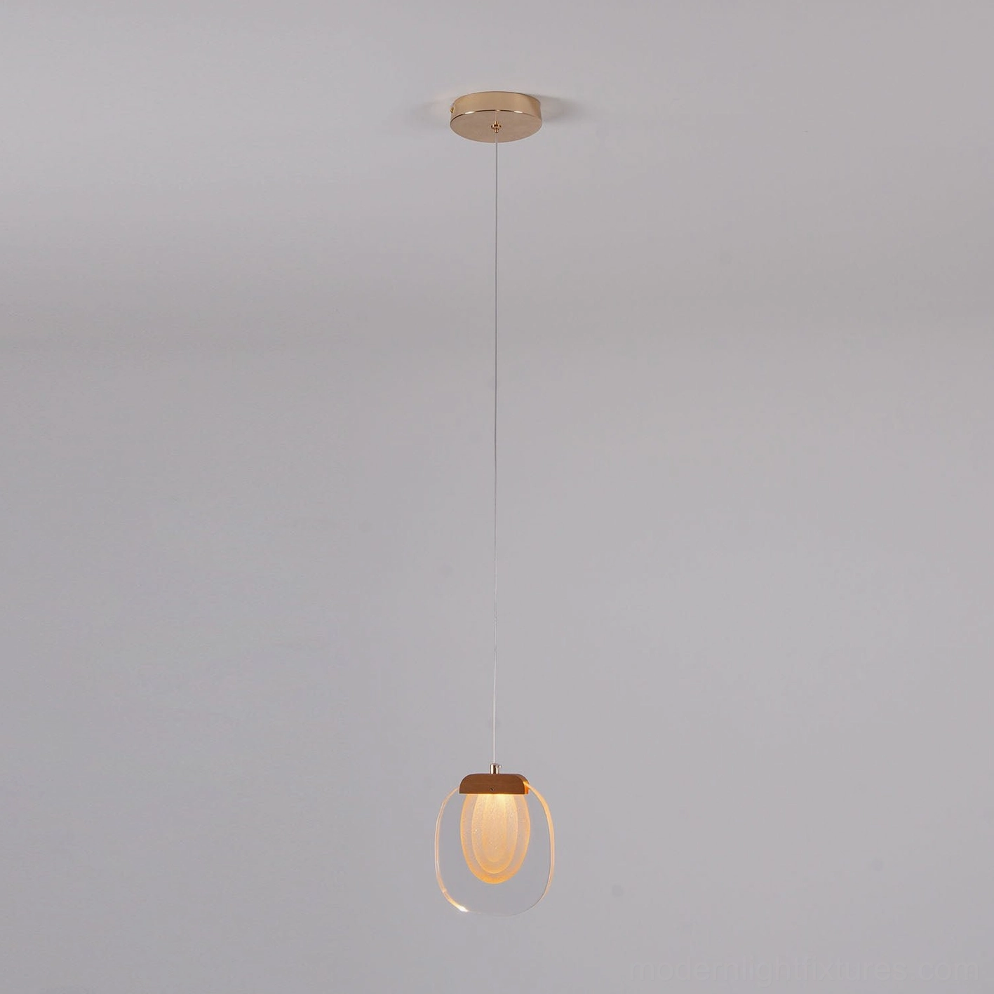Artisan glass ripples pendant light creating atmospheric lighting in modern interior space