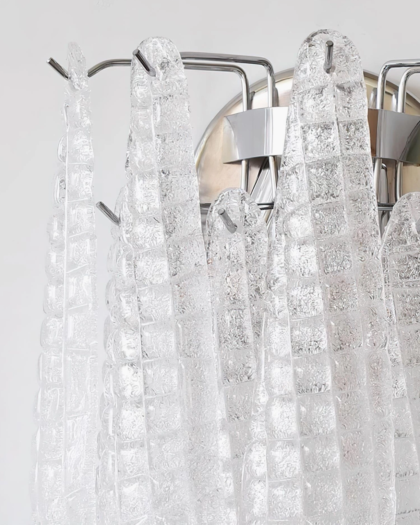 Artisan handcrafted glass wall sconce with polished chrome hardware and modern design