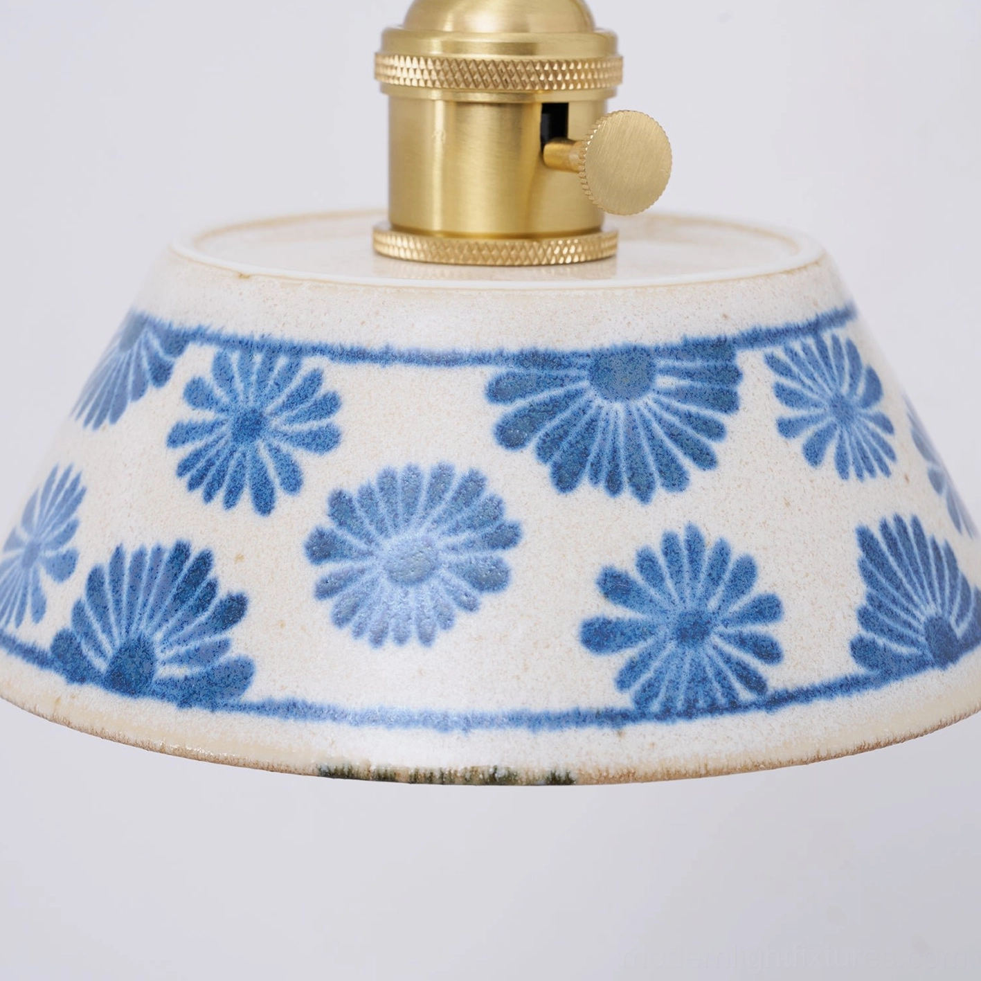 Artisan ceramic sconce with hand-painted indigo patterns and sculptural design form