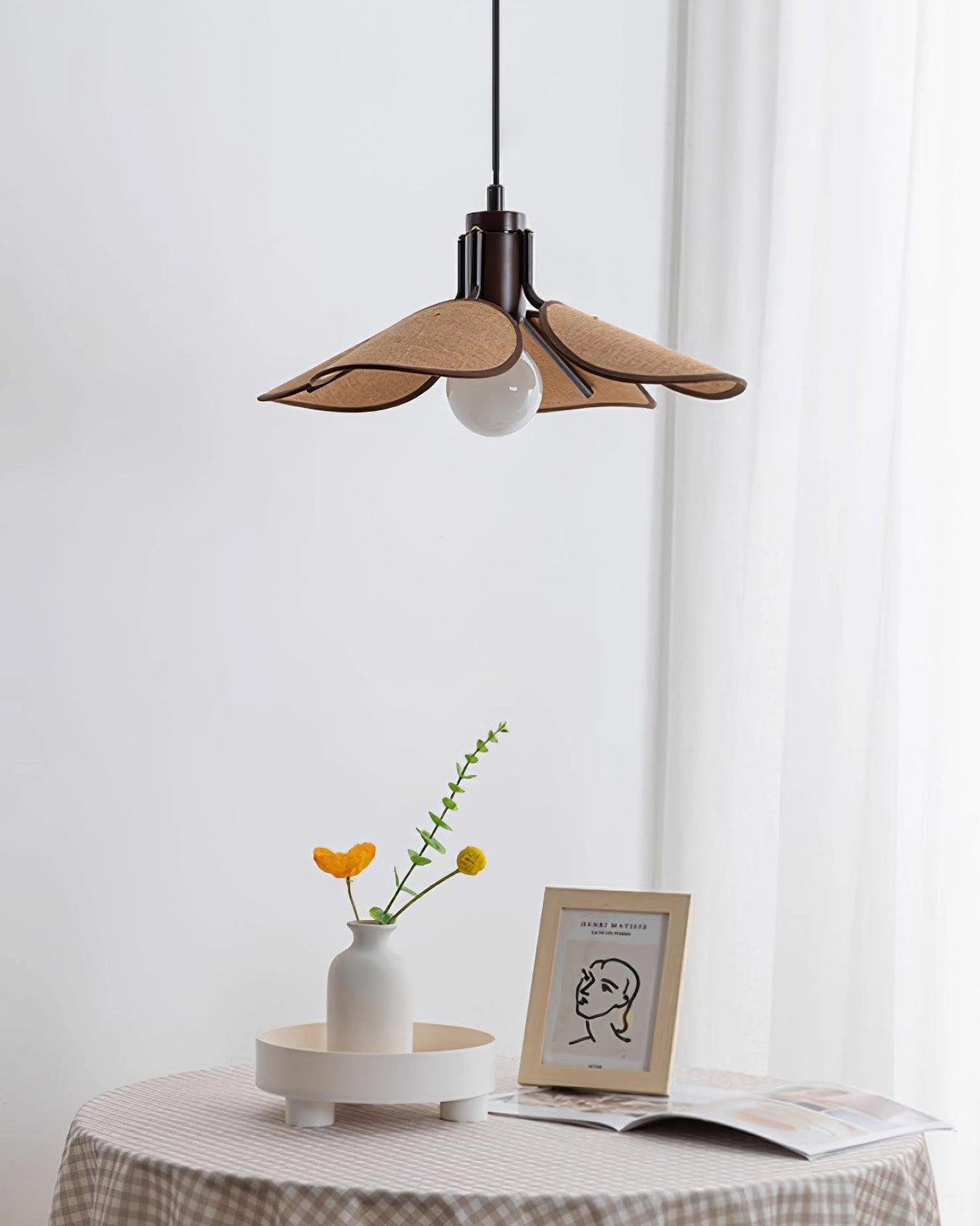 Artisan rattan flower pendant lamp overhead view with warm ambient lighting and dining décor