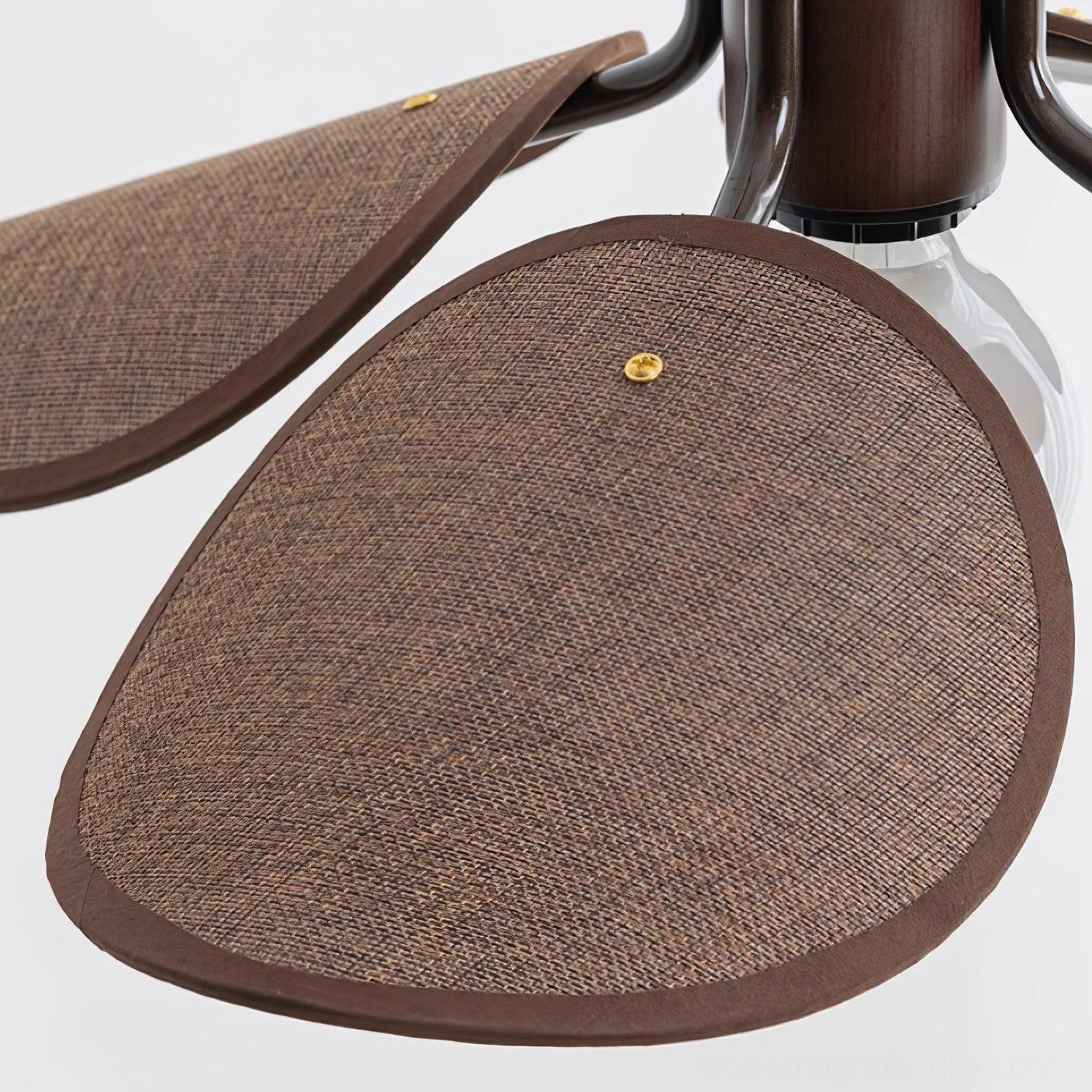 Artisan rattan pendant lamp creating soft diffused light in mid-century modern interior setting