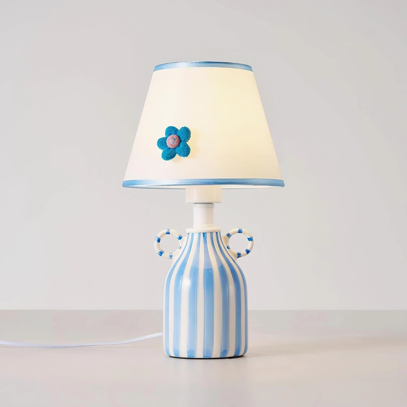 Blue and white striped ceramic table lamp showcasing handcrafted artisanal lighting design