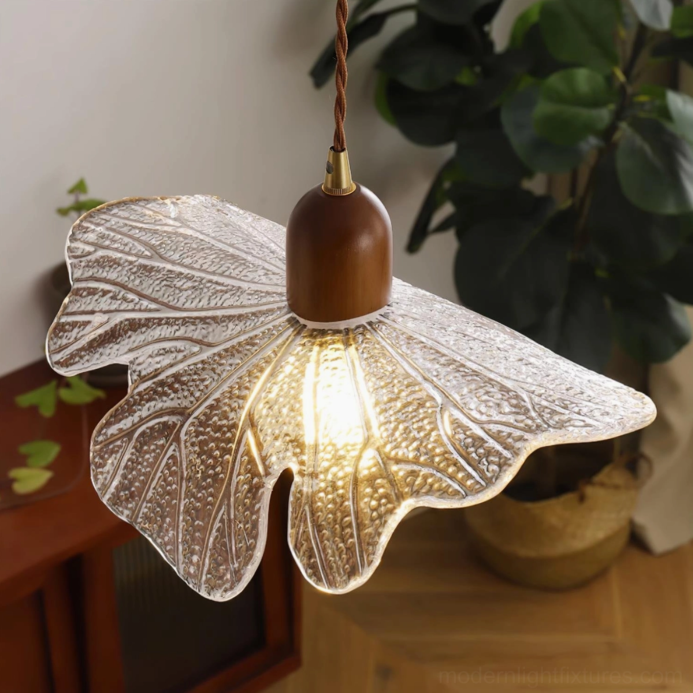 Artisanal glass petal pendant light with diffused warm illumination and organic aesthetic