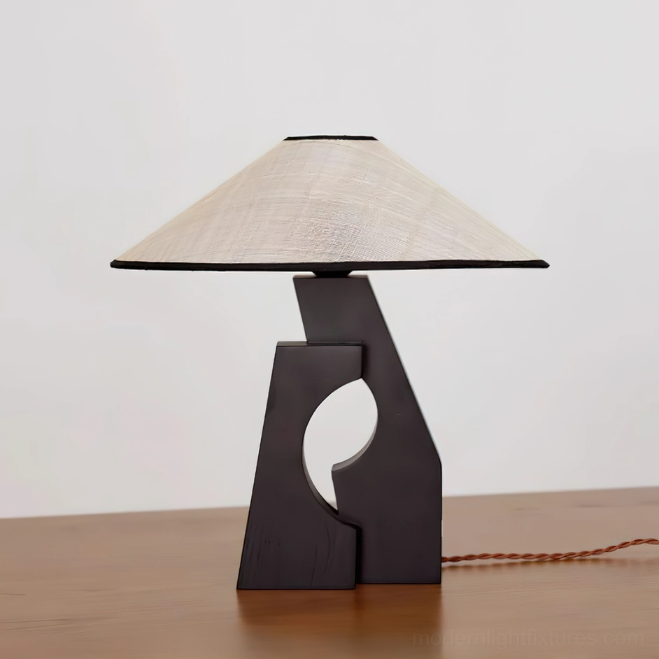 Minimalist wooden base table lamp three-quarter view on natural wood table with warm ambient lighting