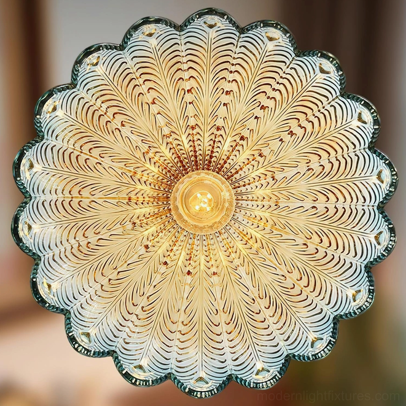 Artistic blue glass pendant light with embossed peacock pattern and ruby red decorative accents close-up