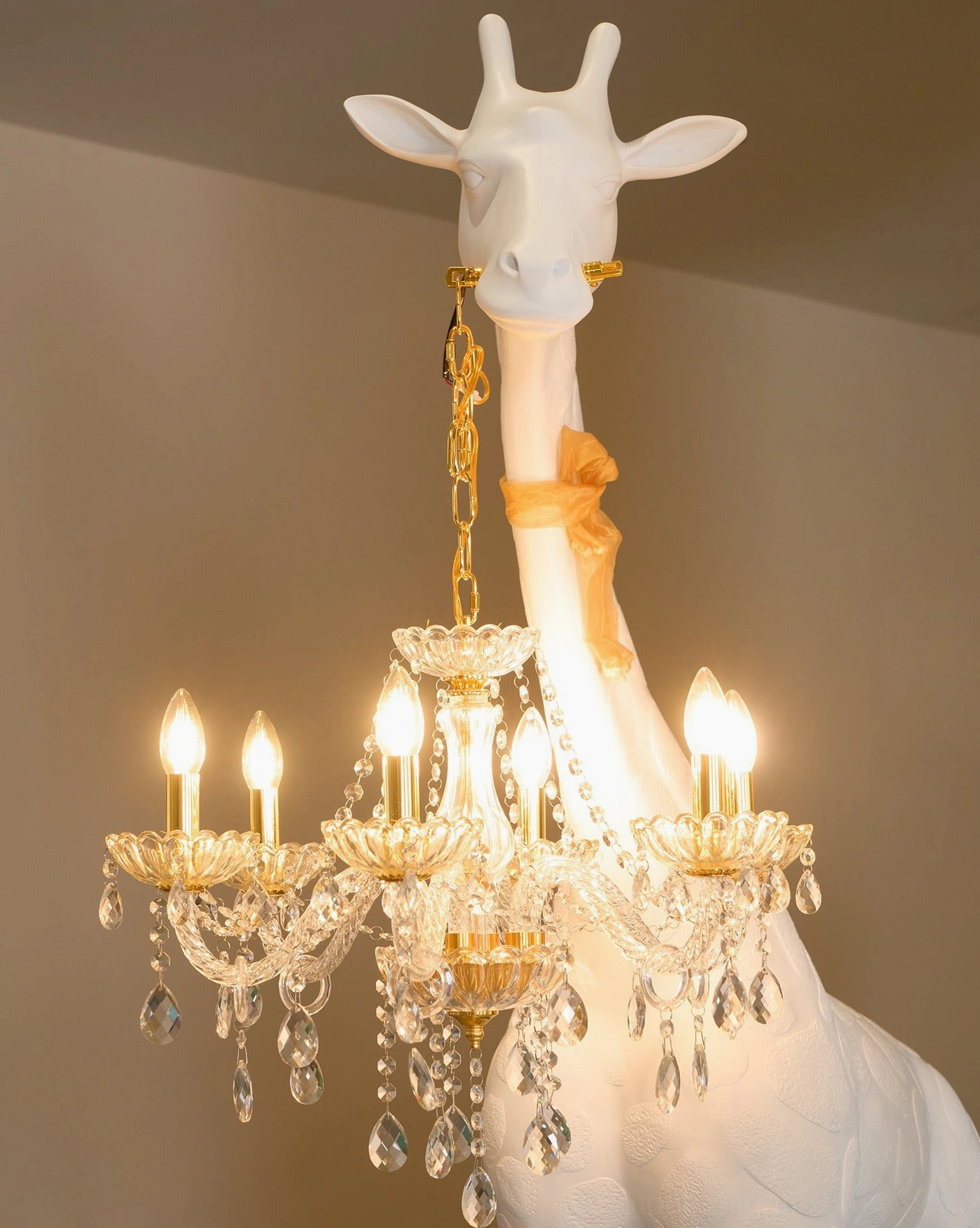 Artistic giraffe floor lamp showing detailed resin sculpture and crystal chandelier lighting composition