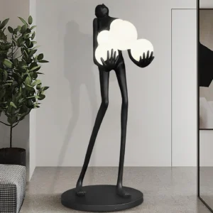 Contemporary sculptural figure floor lamp in modern living room with potted plant accent