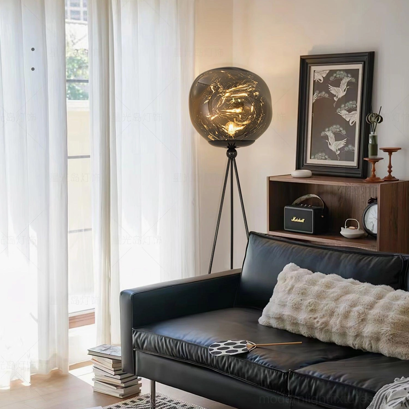 Modern artistic tripod floor lamp featuring molten glass shade with warm golden tones and ambient glow