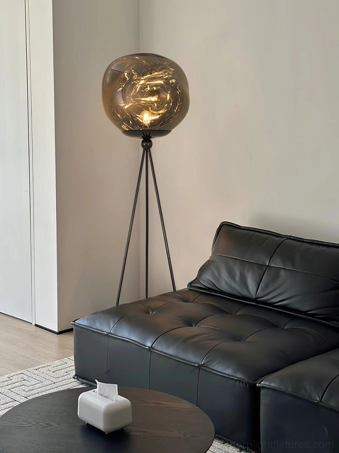 Modern artistic tripod floor lamp with molten lava glass shade and stable metal tripod base construction