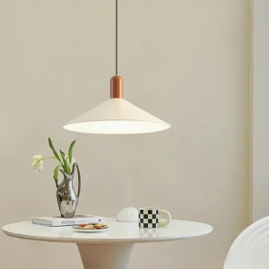 Arundel modern pendant lamp above cozy dining nook, warm ambient lighting with off-white shade and wooden top