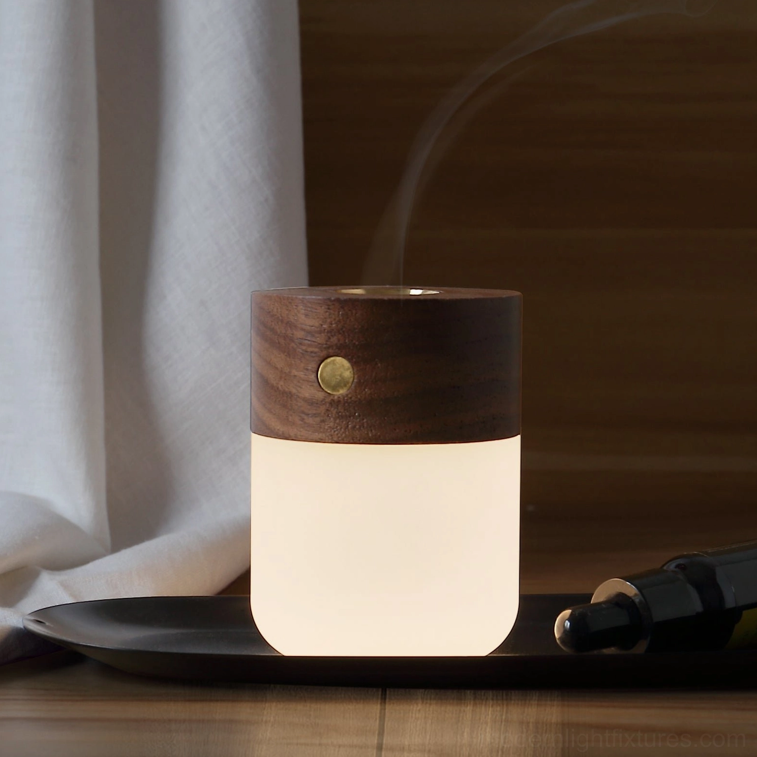 Ash wood aroma diffuser lamp with frosted glass chamber and warm white 3000K LED light on wooden surface
