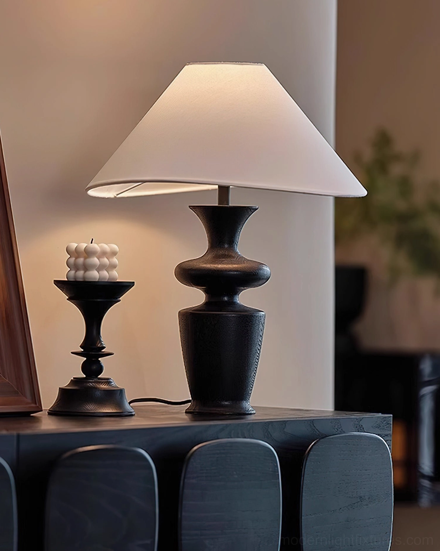Ash wood table lamp displayed on dark modern sideboard with black metal candle holder, contemporary interior lighting solution