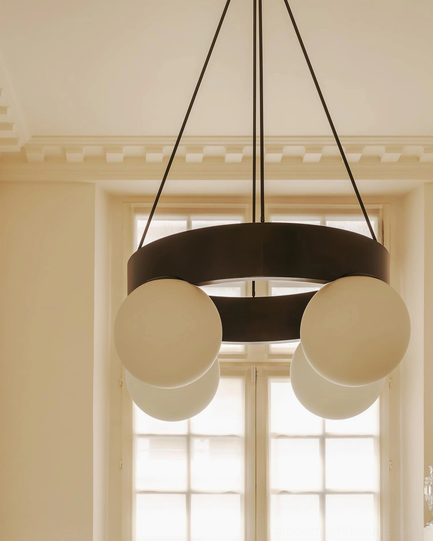 Modern black ring globe chandelier by window in farmhouse dining space - warm beige glass shades