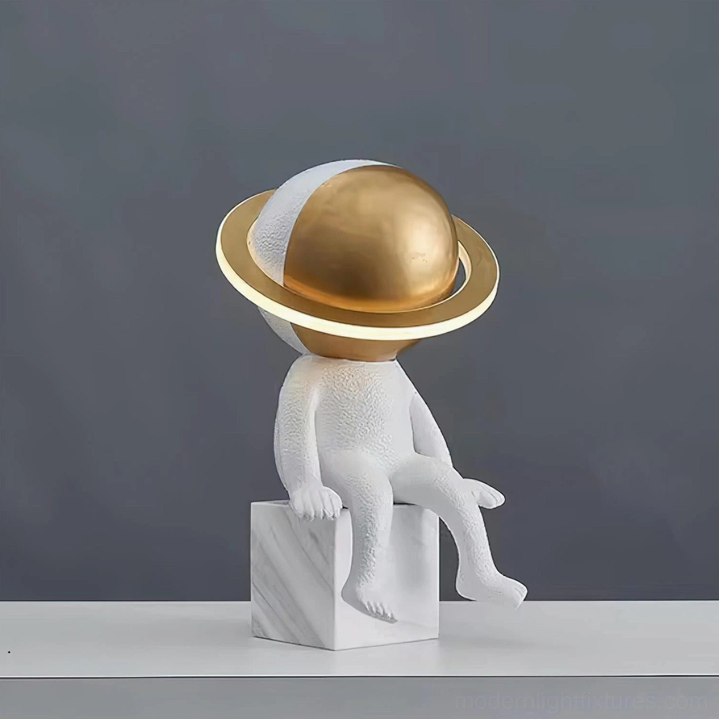 Astronaut Halo LED table lamp with golden orb and marble square base front view