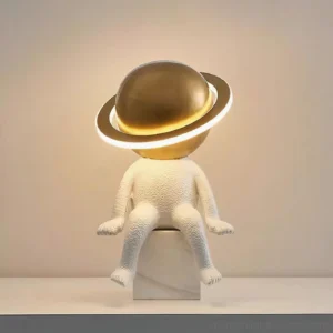 Modern astronaut table lamp illuminated on shelf with warm ambient glow and textured white resin body
