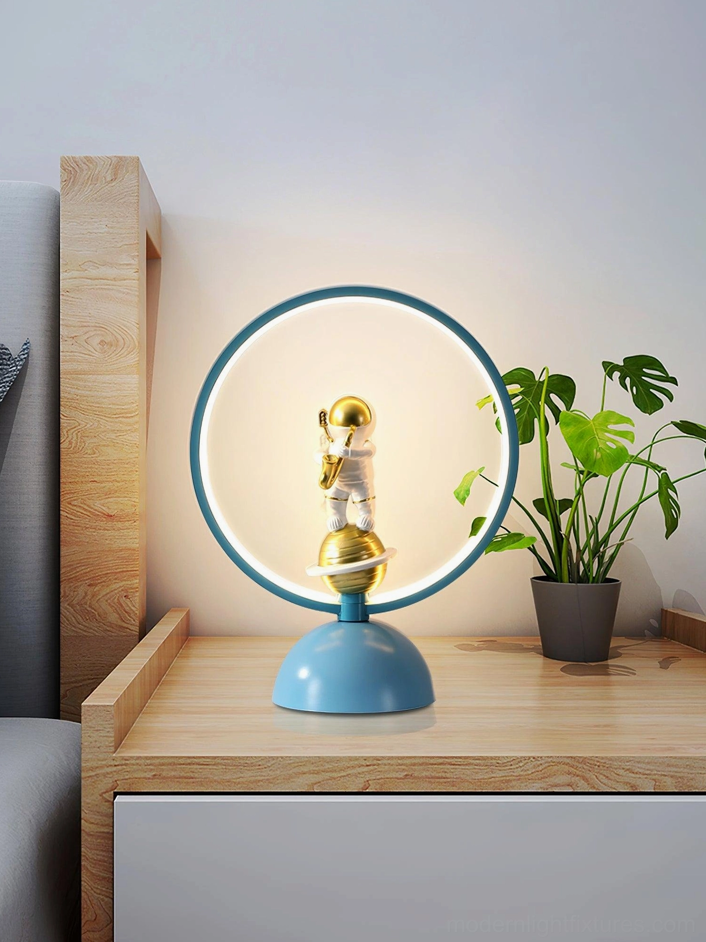 Modern blue LED astronaut lamp on bedroom nightstand minimalist design
