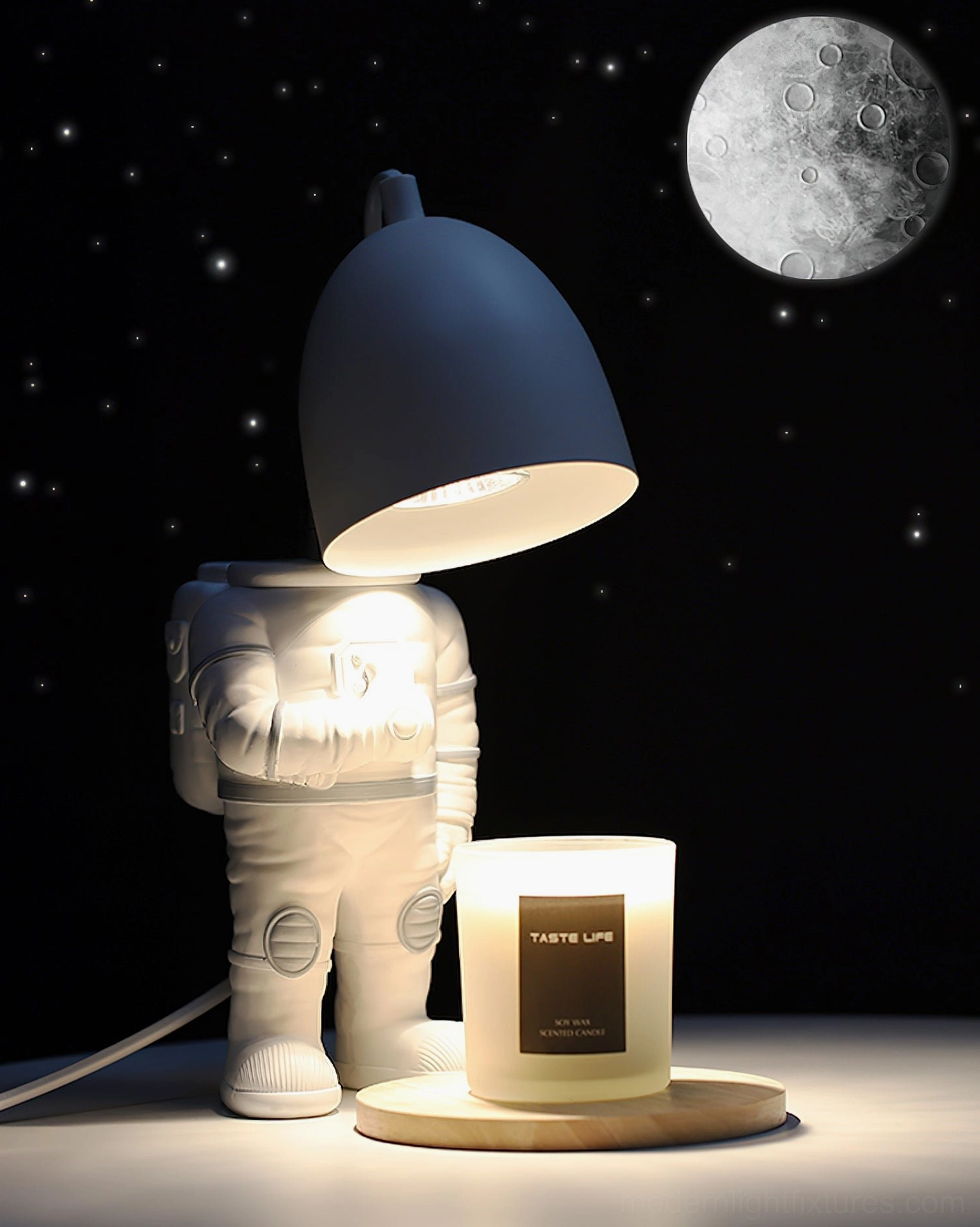 Astronaut candle warmer lamp three-quarter view with dark gray shade and wooden candle base against starry moon background