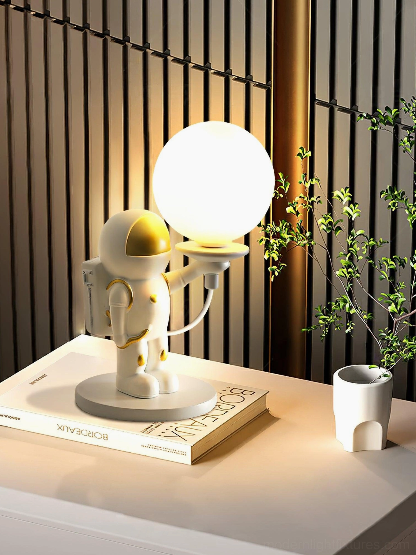 Astronaut spherical table lamp on wooden surface with warm gold accents