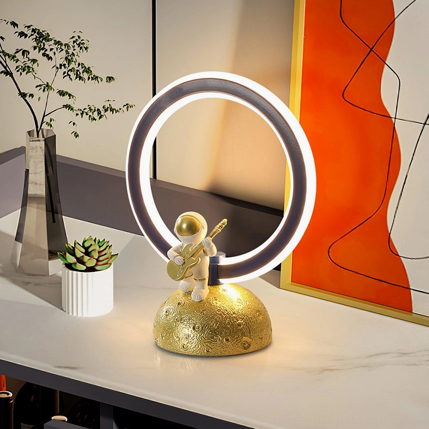 Contemporary astronaut LED lamp marble countertop indoor display setting