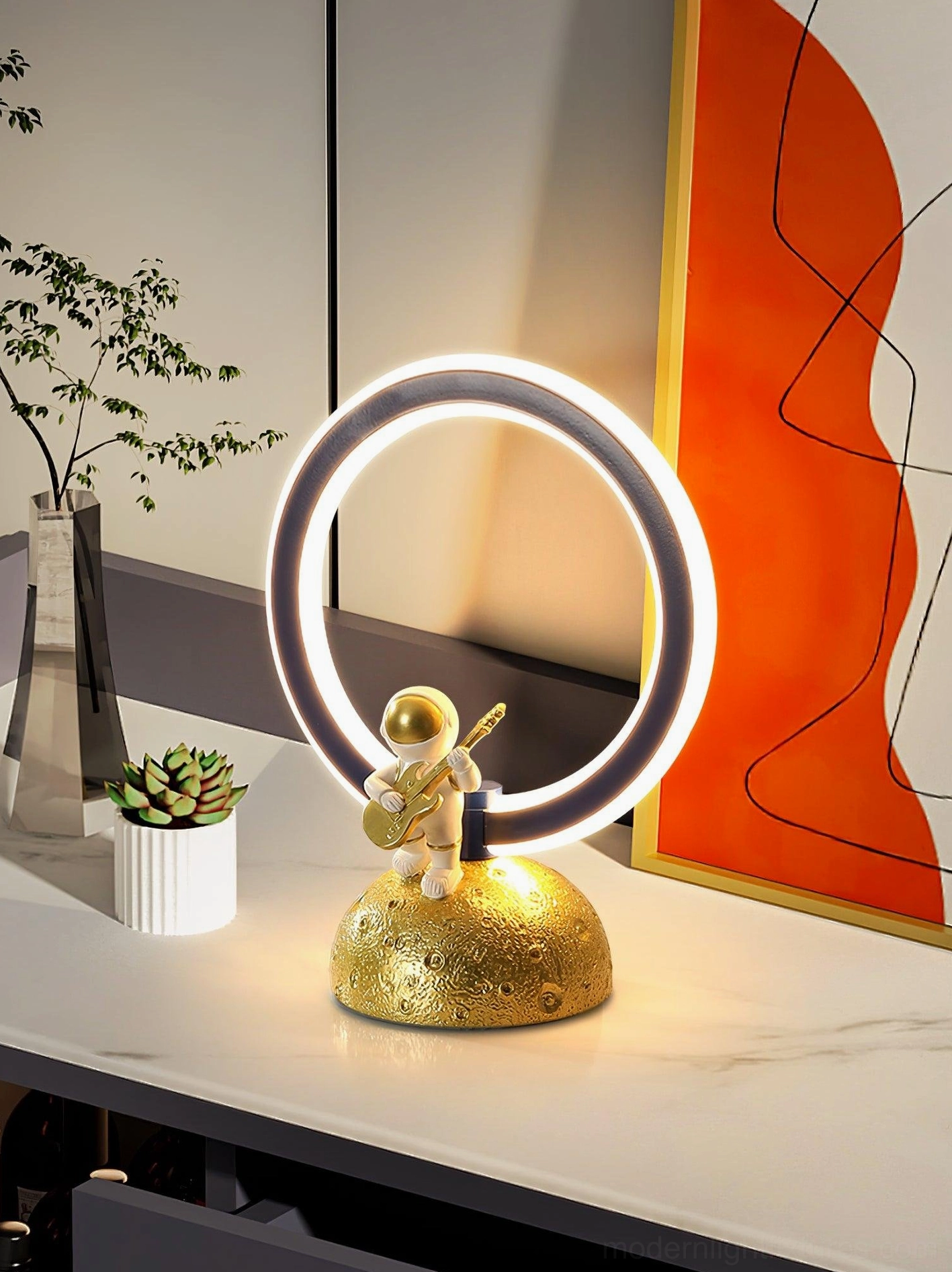 Astronaut guitar ring lamp three-quarter view with gold moon base and wall art
