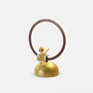 Astronaut table lamp with gold lunar base and resin body front view