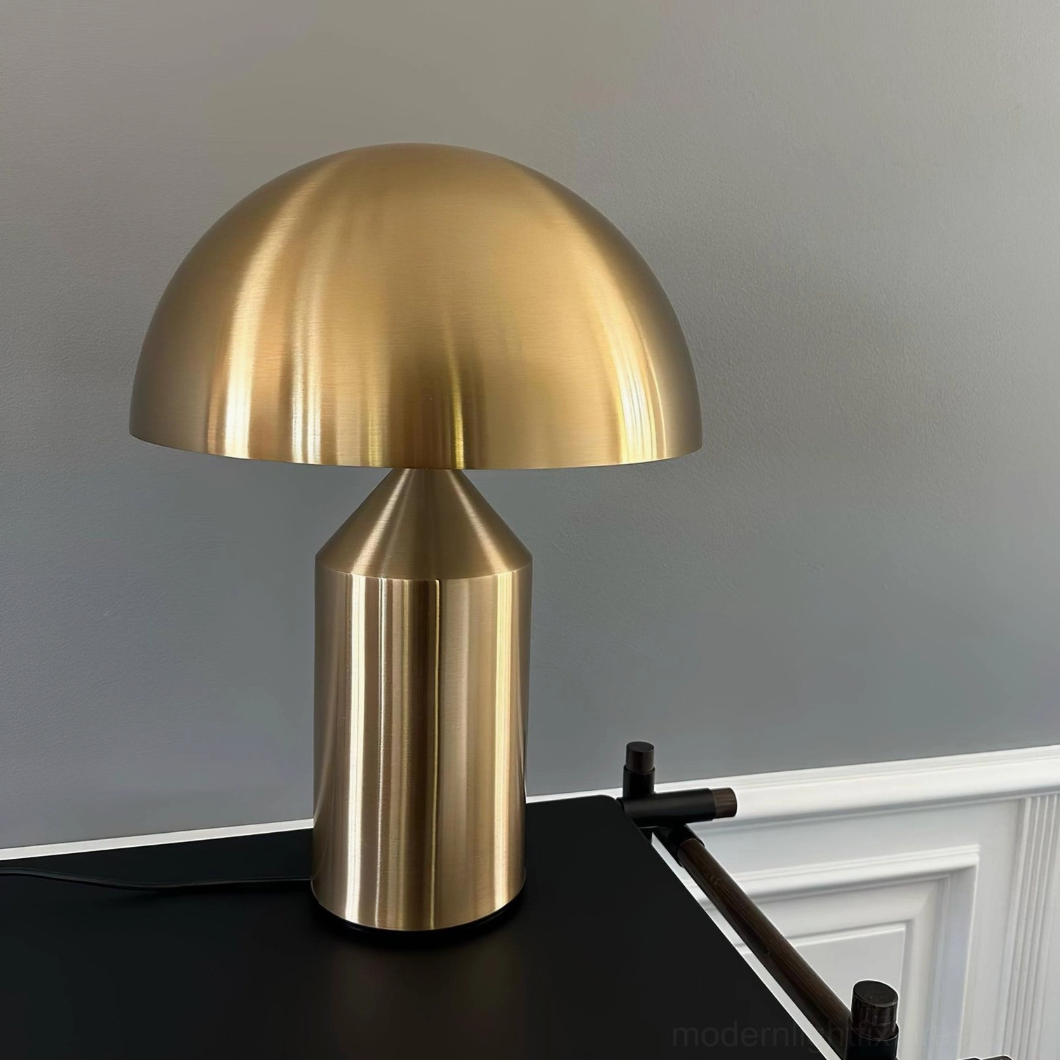 Brass Atollo designer table lamp in modern luxury desk setting