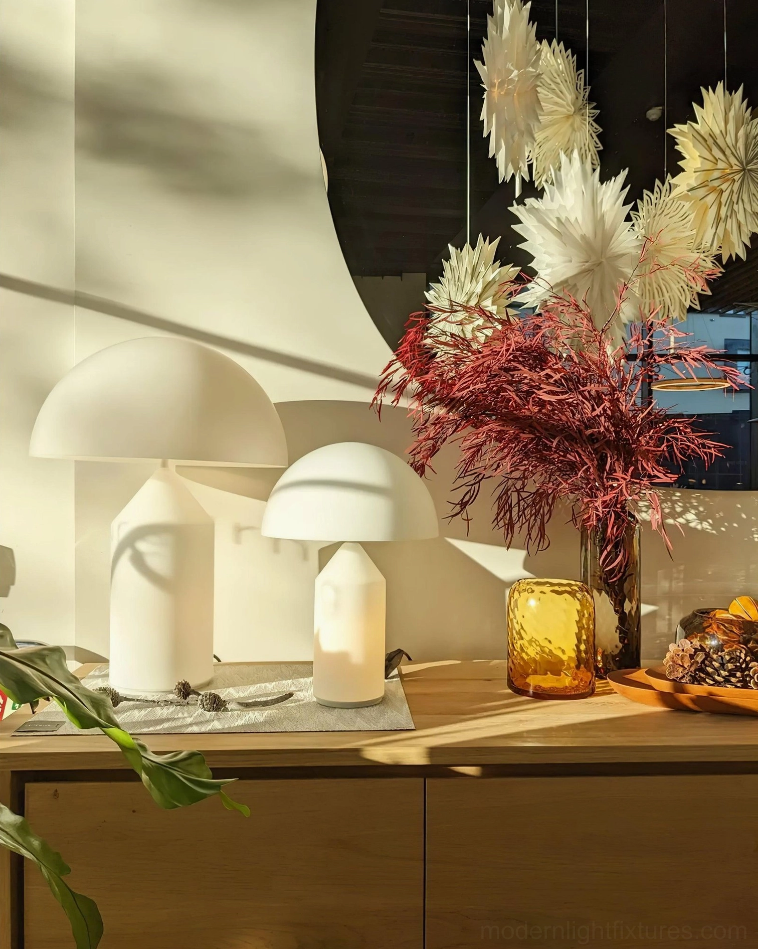 Atollo mushroom table lamps on decorative console table with floral styling