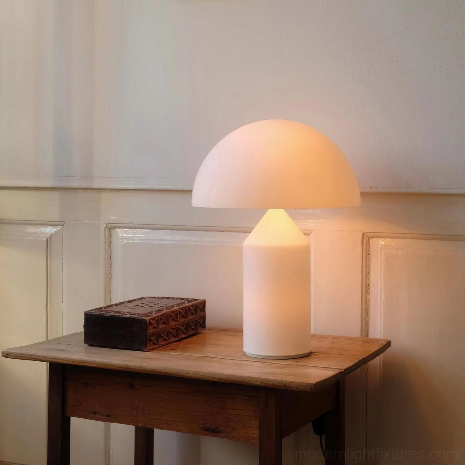 Matte white Atollo table lamp with retro minimalist styling on vintage paneled wall