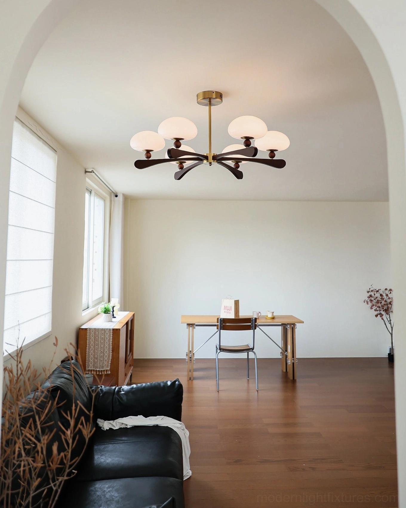 Modern atomic-age inspired chandelier with radial dark walnut wood arms and warm gold-tone metal construction—sculptural mid-century fixture