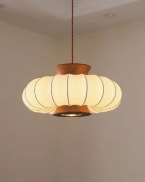 Modern fabric pendant light with warm glowing 3000K LED illumination, wooden ceiling mount, eye-level indoor view