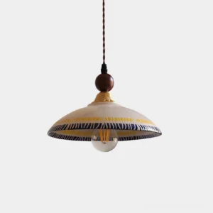 Avelin ceramic pendant light with hand-applied patterns and brass hardware, front view on white background