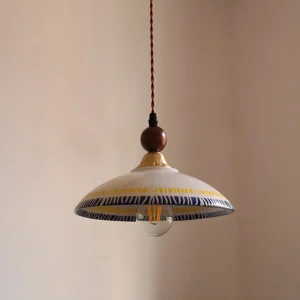 Close-up detail of Avelin pendant lamp showing ceramic shade with decorative patterns and twisted brown suspension cord