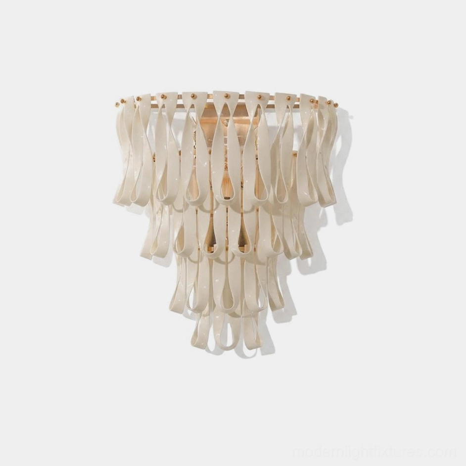 Avelisse ceramic ribbon wall sconce front view with matte white finish and warm gold metal accents on white background