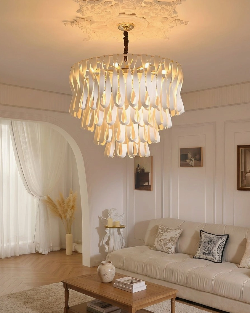 Avelisse round tiered pendant chandelier in bright neutral living room with sofa coffee table and draped curtains