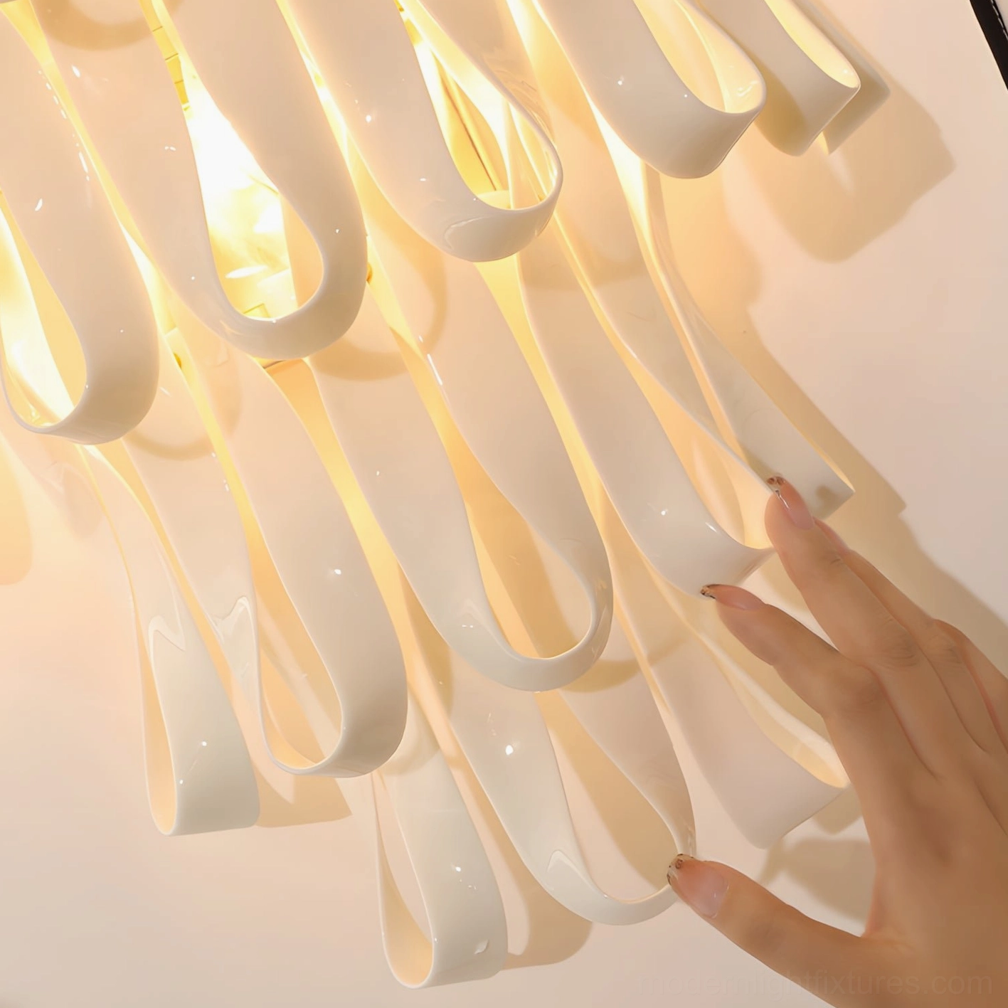 Three-light ceramic ribbon wall sconce illuminating dark feature wall creating luxury architectural ambiance