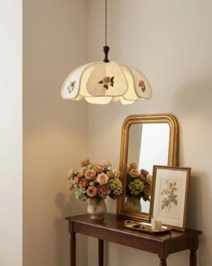 Avenelle embroidered pendant light hanging in vintage French country entryway, three-quarter perspective with console table and warm ambient lighting