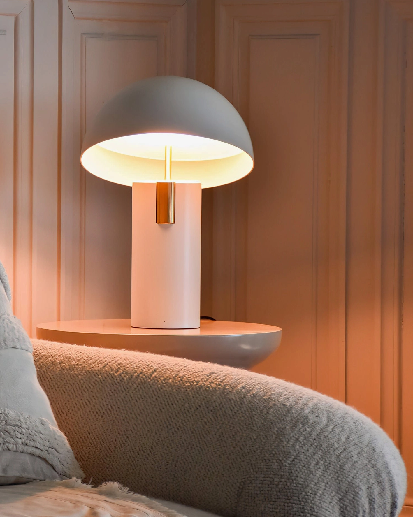 Two-tone Avo table lamp with gray shade and pink base featuring brass trim, minimalist modern design detail