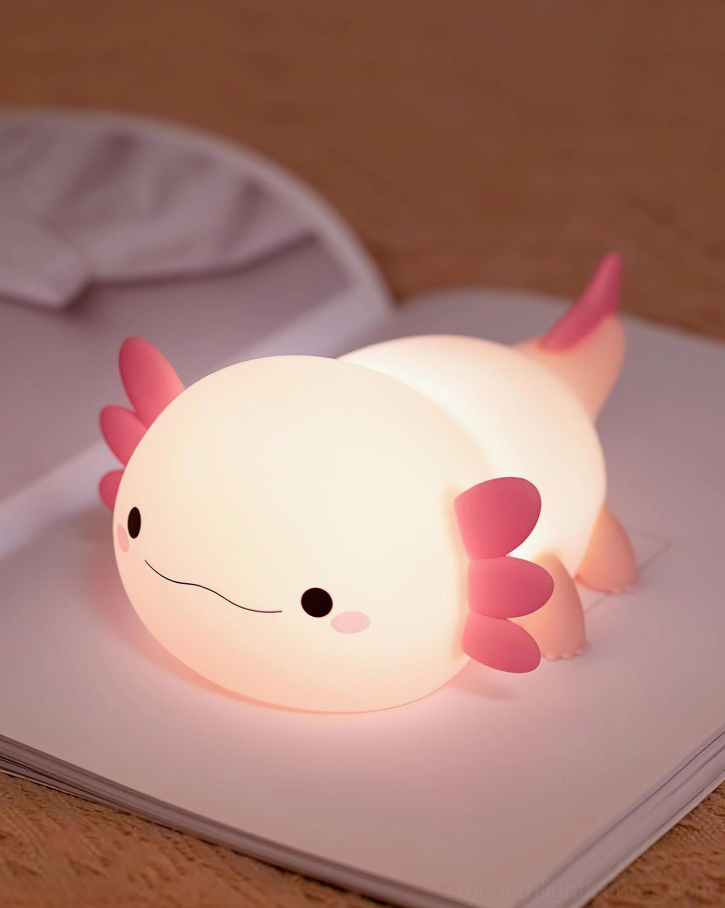 Axolotl-shaped night light glowing warmly on bedside table with notebook, eye-level bedroom view