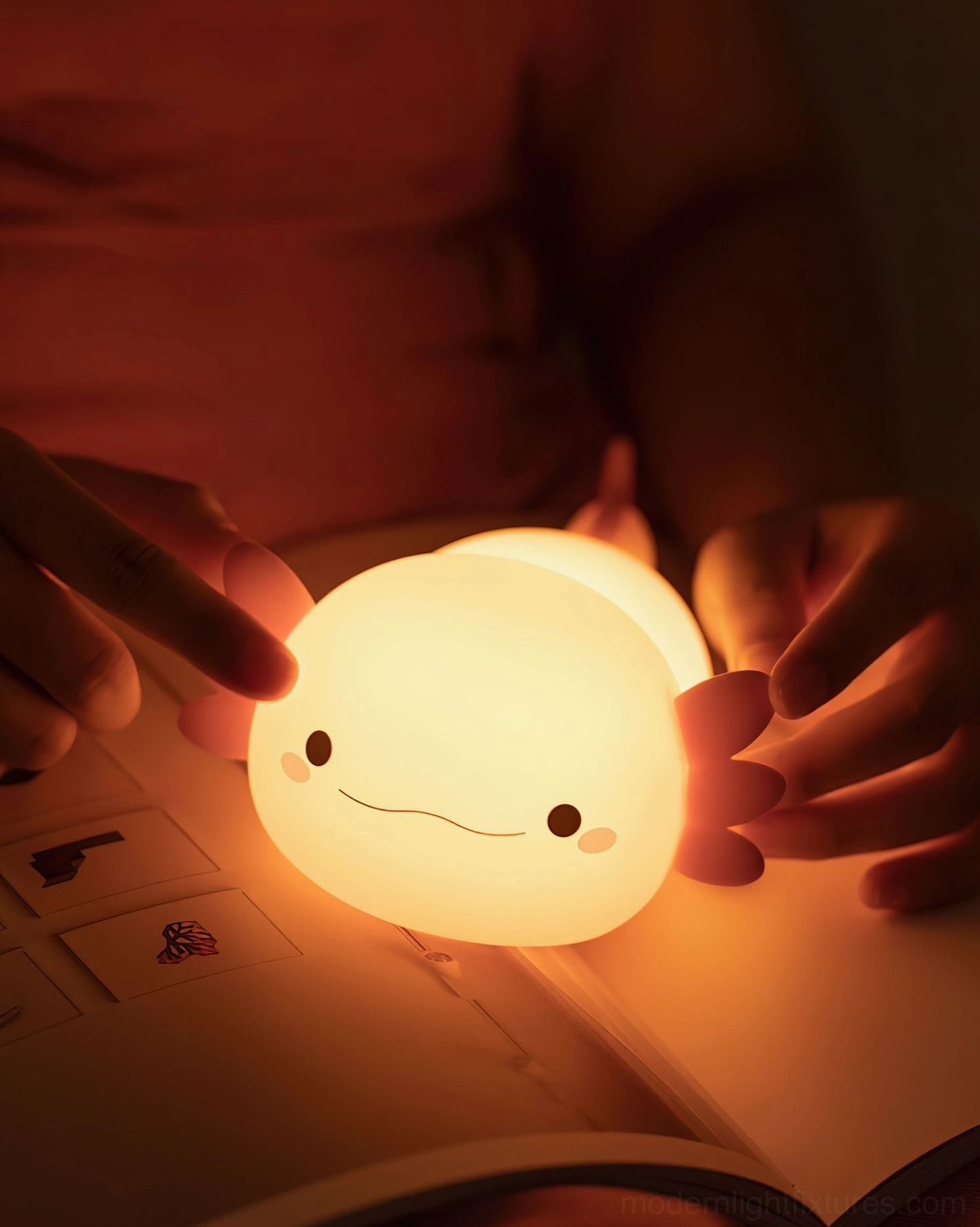 Soft glowing pink axolotl night light creating warm ambient atmosphere in living space