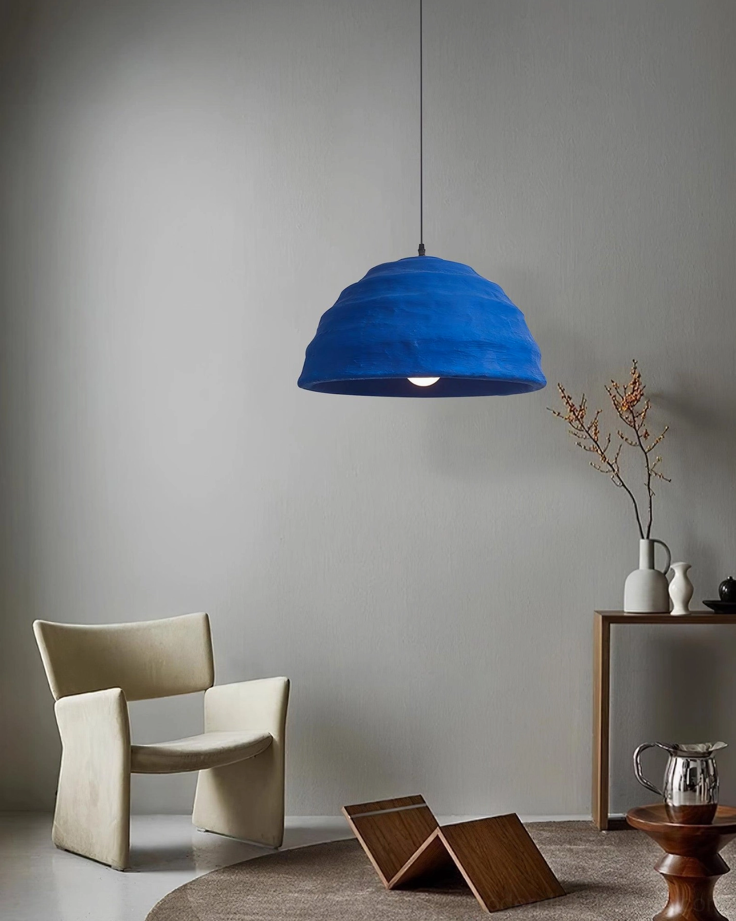 Modern azure blue dome pendant creating ambient glow in minimalist interior design context