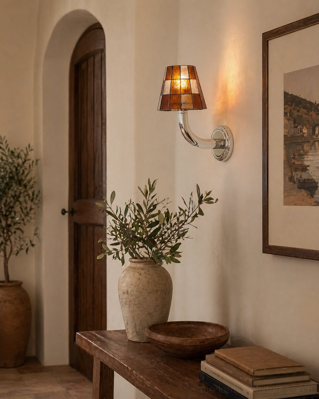 Modern geometric stained glass wall light installed in Mediterranean entryway with amber glass shade and warm glow