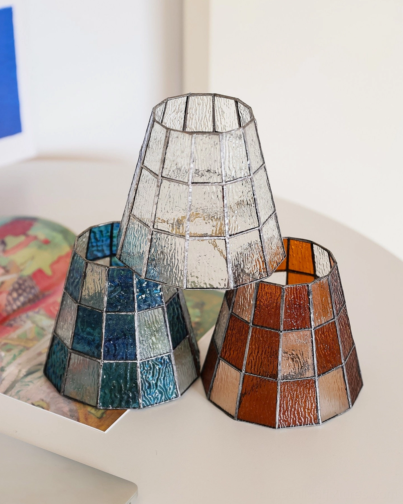 Three color variants of Azurielle stained glass shade - clear grid, blue checkered, and amber checkered patterns