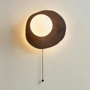 Bacia wooden wall lamp mounted on indoor wall showing warm ambient light and vintage bead pull chain detail
