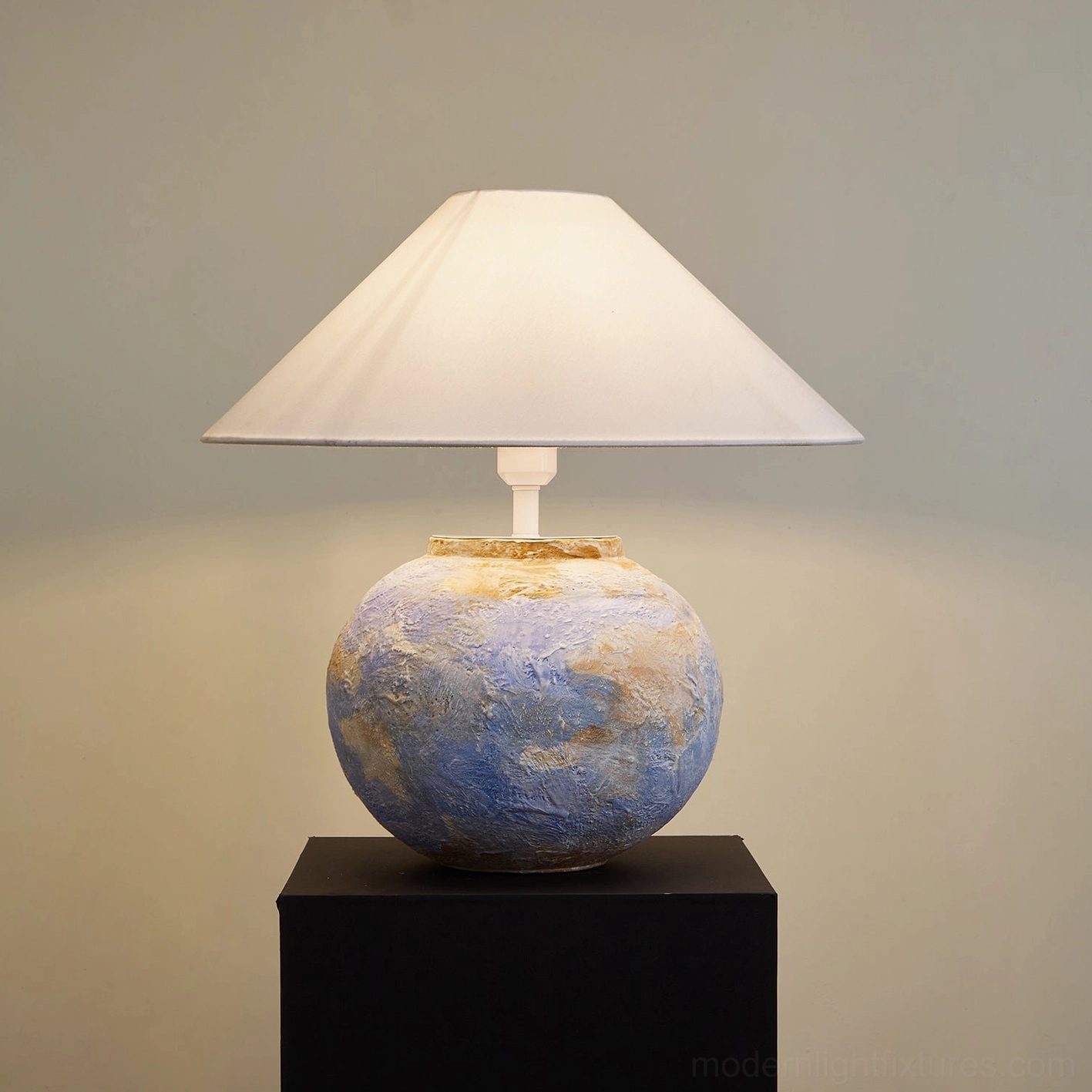 Bailey table lamp illuminated three-quarter view showing warm glow and ceramic texture detail