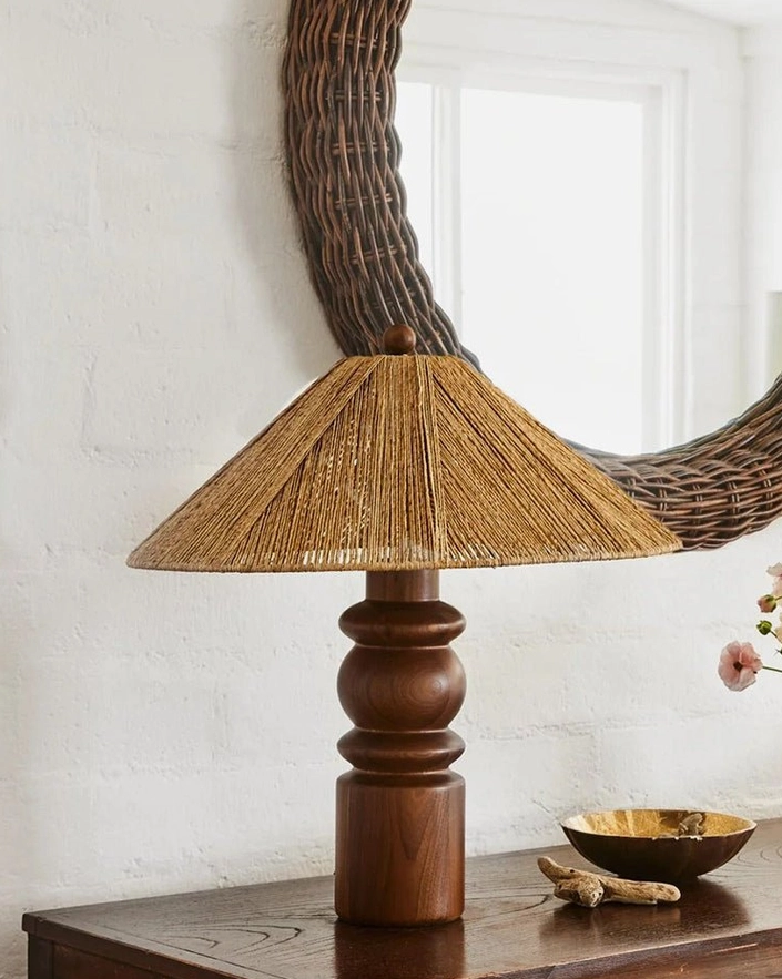 Modern table lamp styled on home console with wicker mirror accessories interior design display