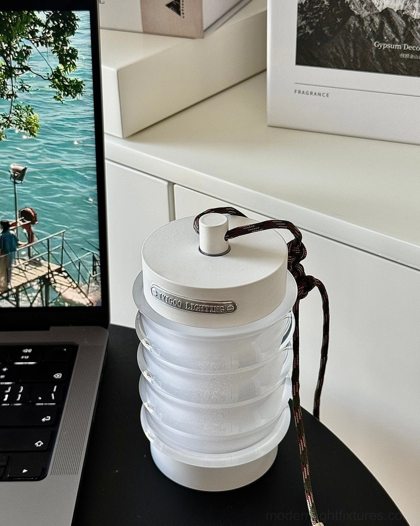 Balia portable LED table lamp showcasing rippled acrylic shade and aluminum metallic accents in contemporary interior setting