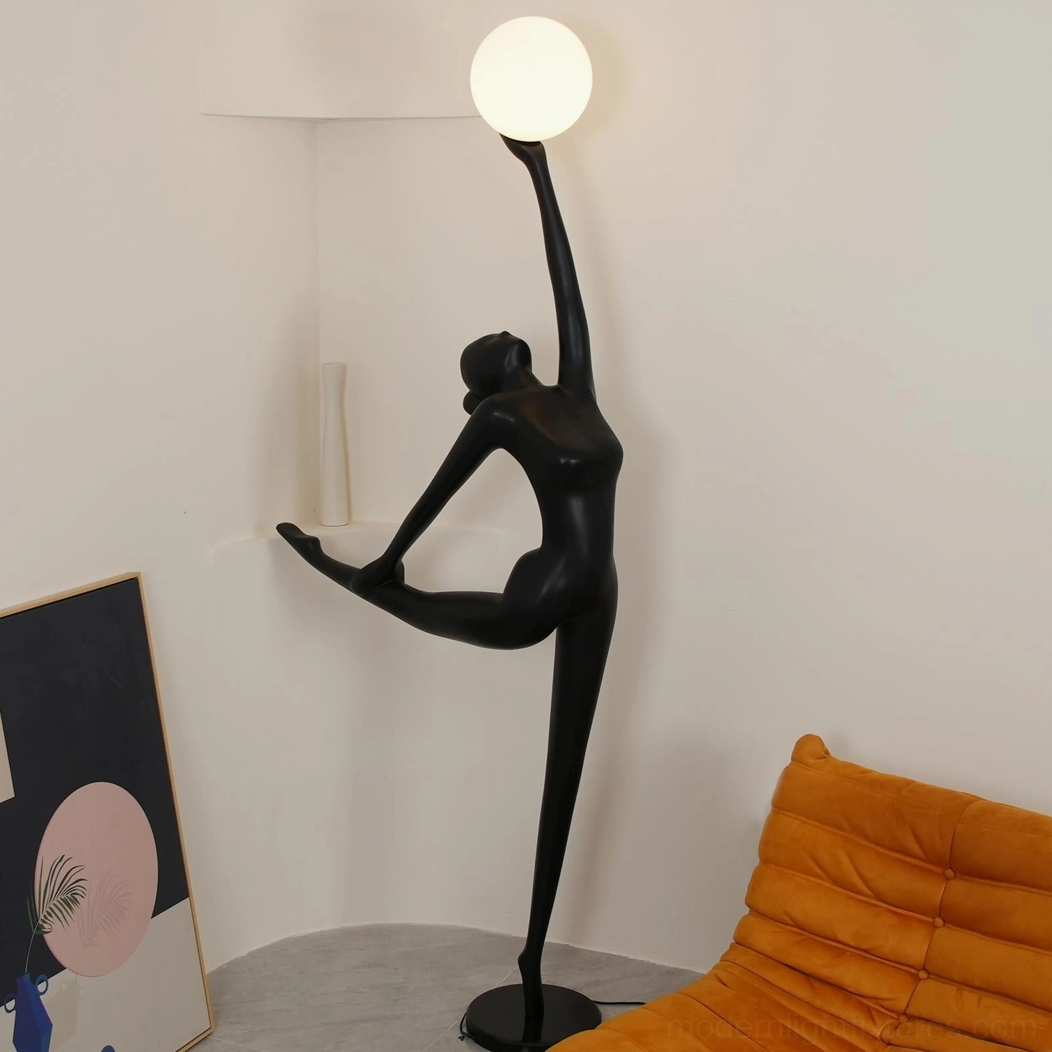 Contemporary ballerina arabesque floor lamp with opal white glass globe in modern living room with orange sofa