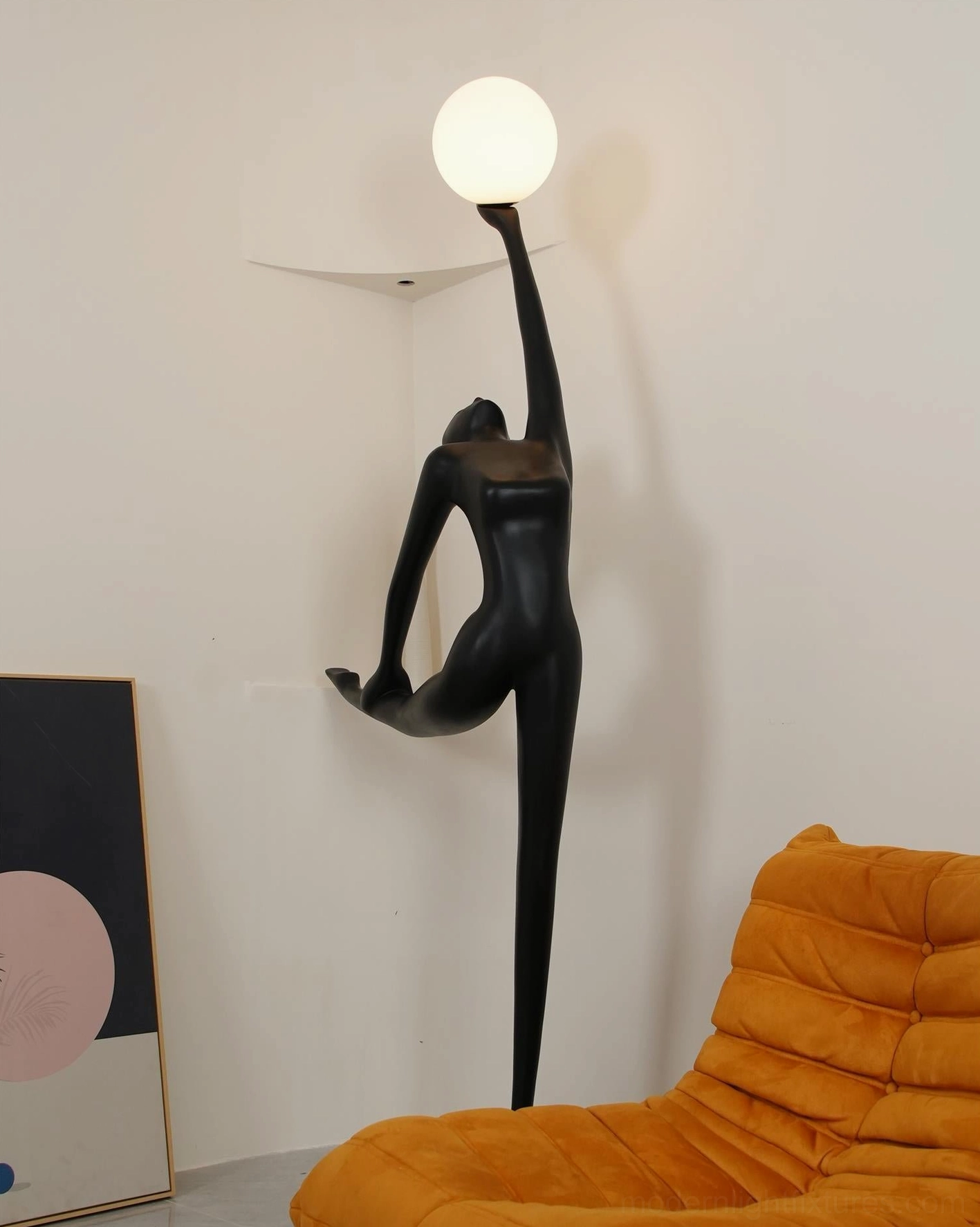 Matte black ballerina dancer floor lamp rear view showing bent arabesque pose in modern interior