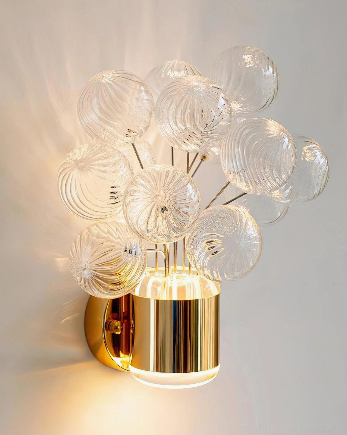 Unlit Balloon Bouquet Wall Sconce showing clear ribbed glass balloon details and shiny gold base fixture against plain wall