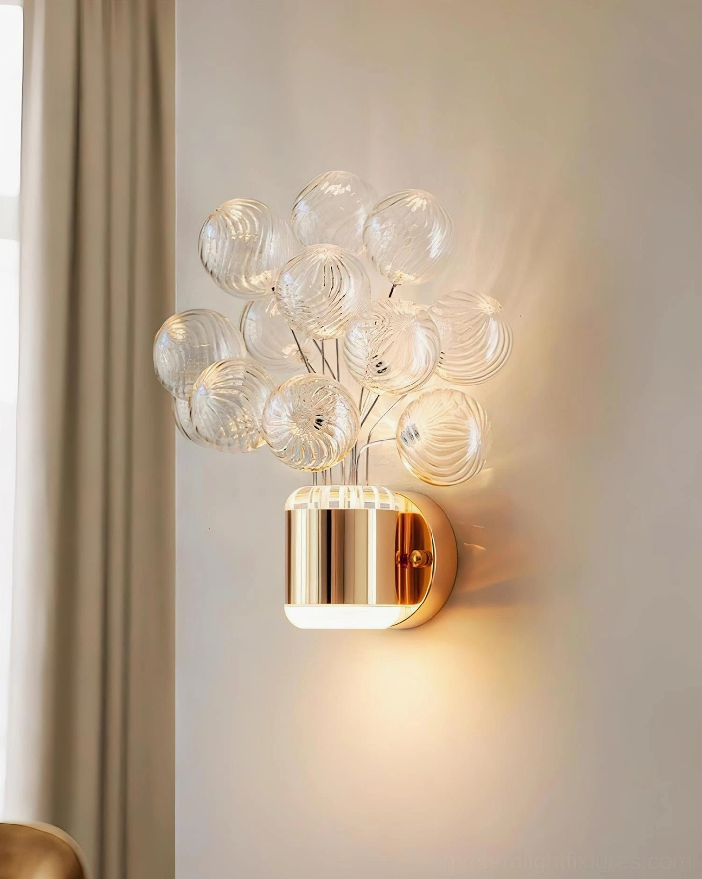 Clear ribbed glass balloon spheres on Balloon Bouquet Wall Sconce fixture with polished gold metal wall mount, unlit studio view